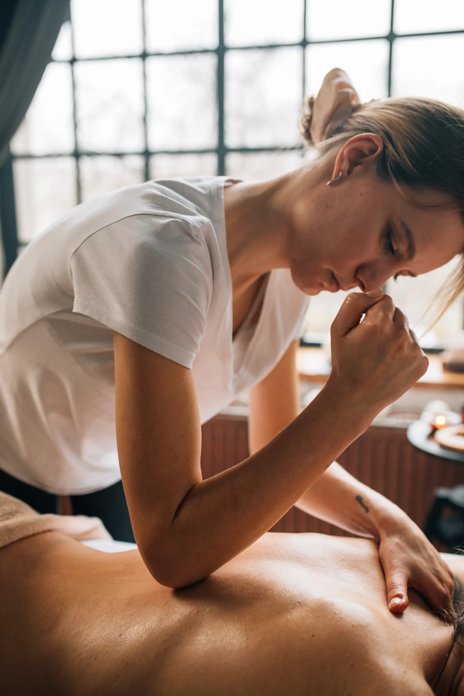 Personal, caring massage therapy session in a relaxing indoor spa